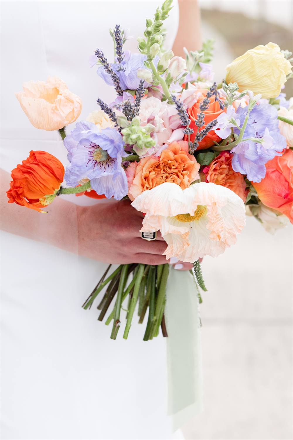 A vivid bouquet of coral and cream ranunculus